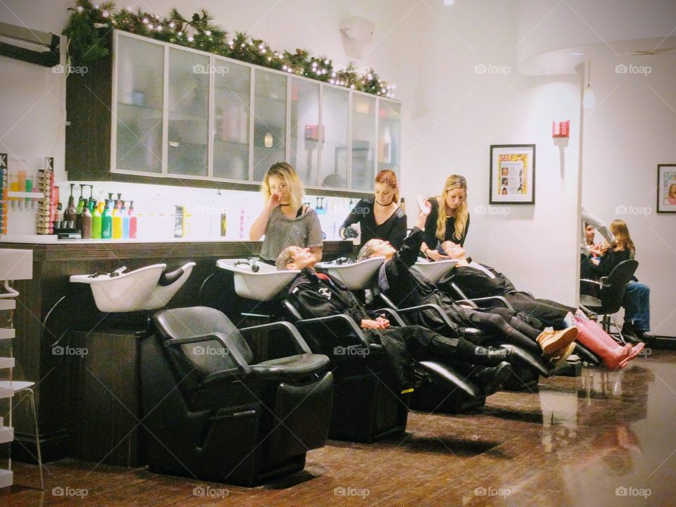 Three women enjoying hair washing at the salon
