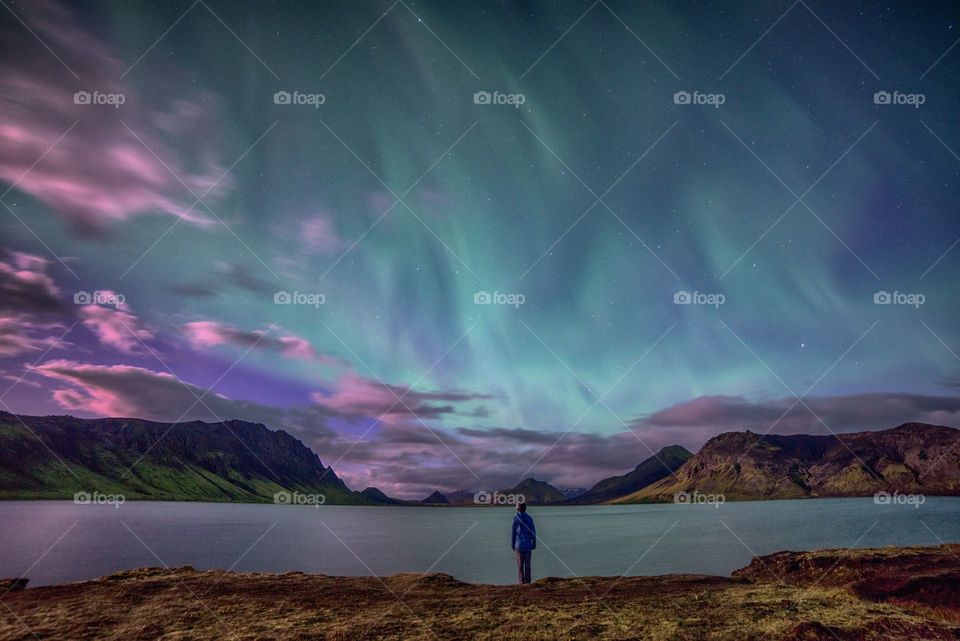 a person stand and watch the beautiful phenomenon of nature, Northern lights
