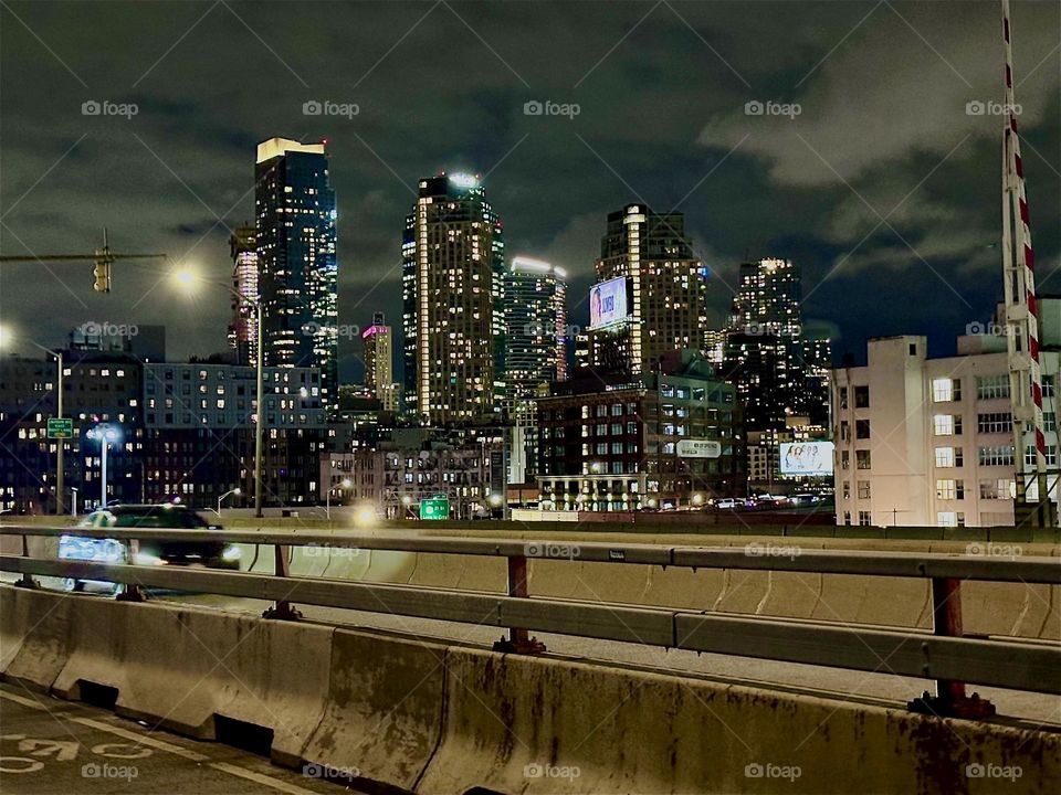 This is the “Pulaski Bridge” at “Newtown Creek” in LIC, Queens with its incessant and speedy car traffic. The bridge connects “Greenpoint”, Brooklyn to LIC. As the cars zoom by their glaring headlights illuminate the road. 2023. Hypnotic Productions