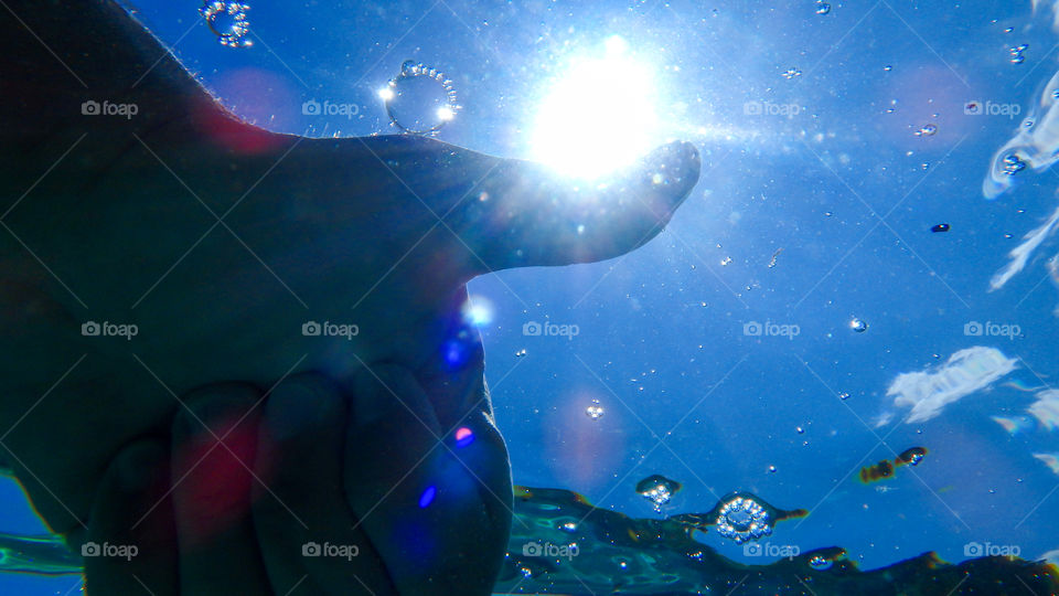 man giving thumb up underwater