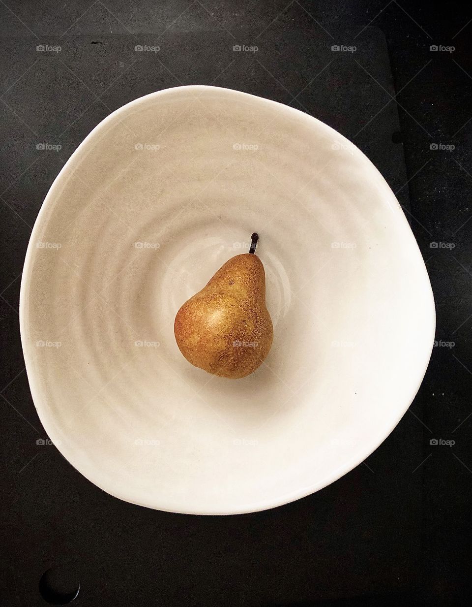 Foap Mission Focus! Simplicity Focus On A Pear in A White Bowl With Black Background!