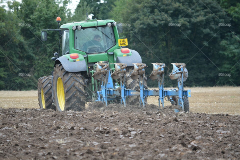 Plough at work. Busy local harvest 
