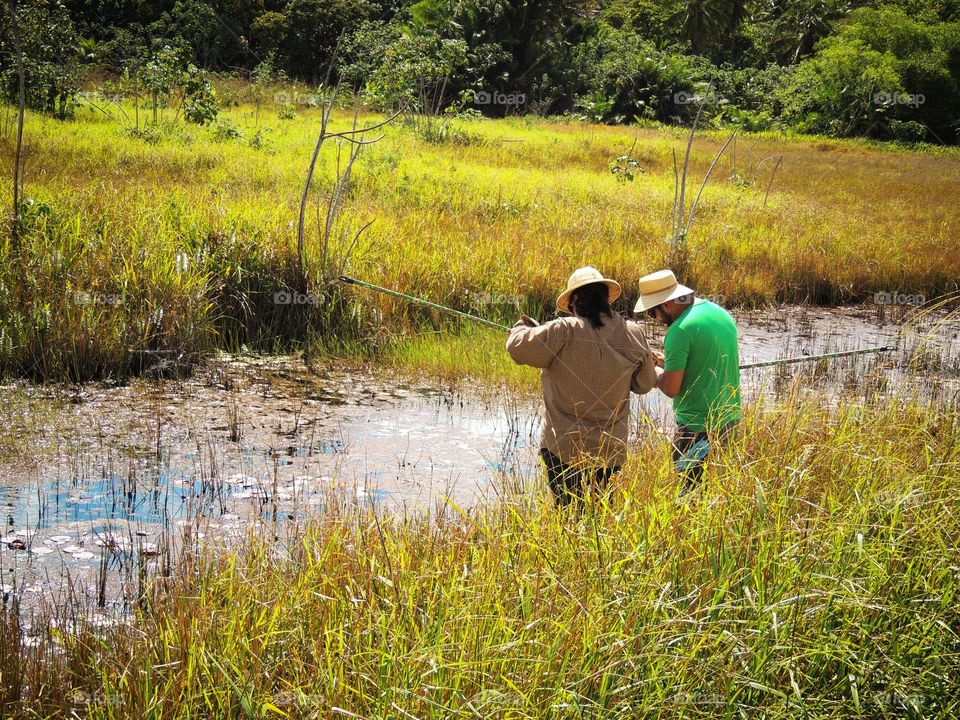 A couple arranging their rods to catch something, hoping to have more time to do what they like on a daily basis 