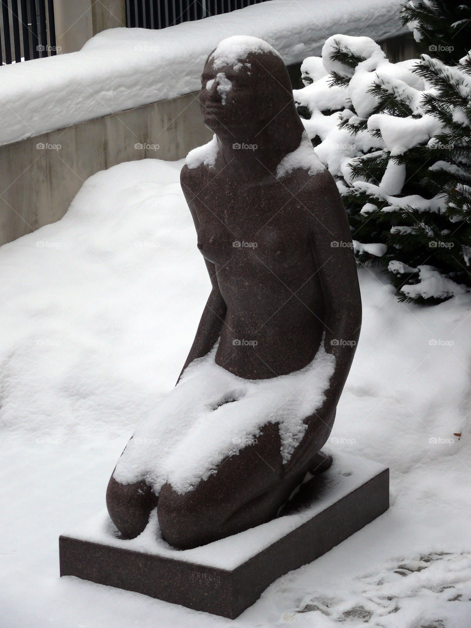 Snow covered sculpture during winter in Riga, Latvia.