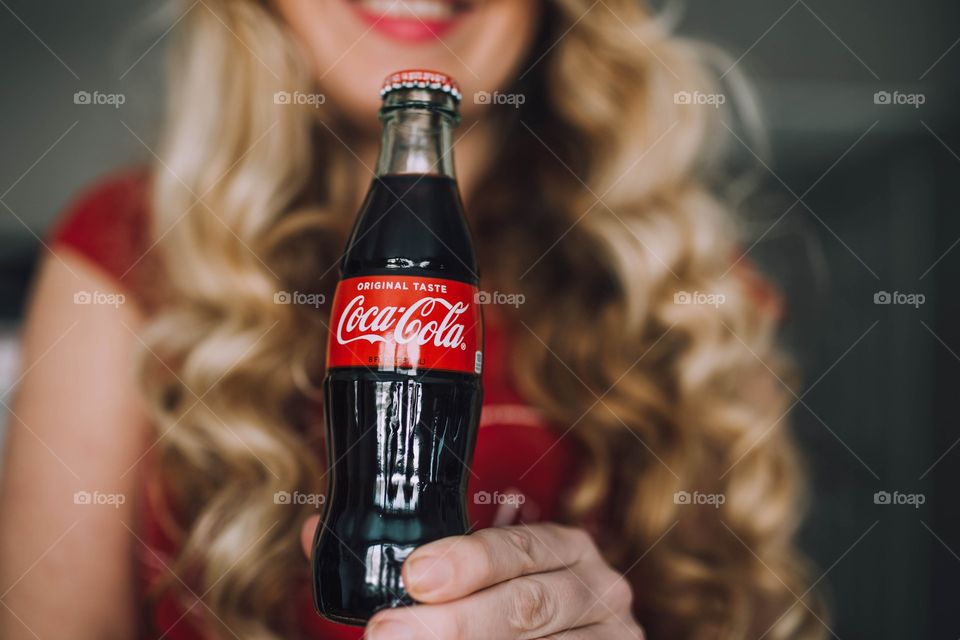 Girl holding a Coca Cola bottle 