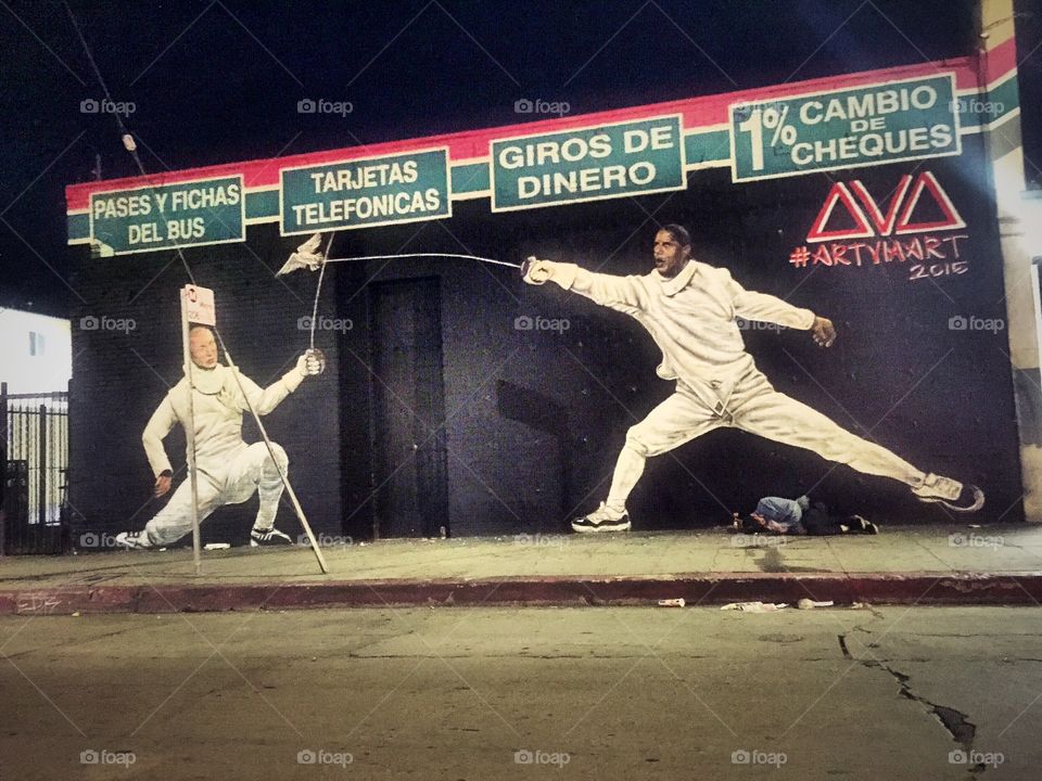 Putin & Obama Fencing. Street art at a liquor store along Hollywood Blvd.  The guy on the foreground says it all.