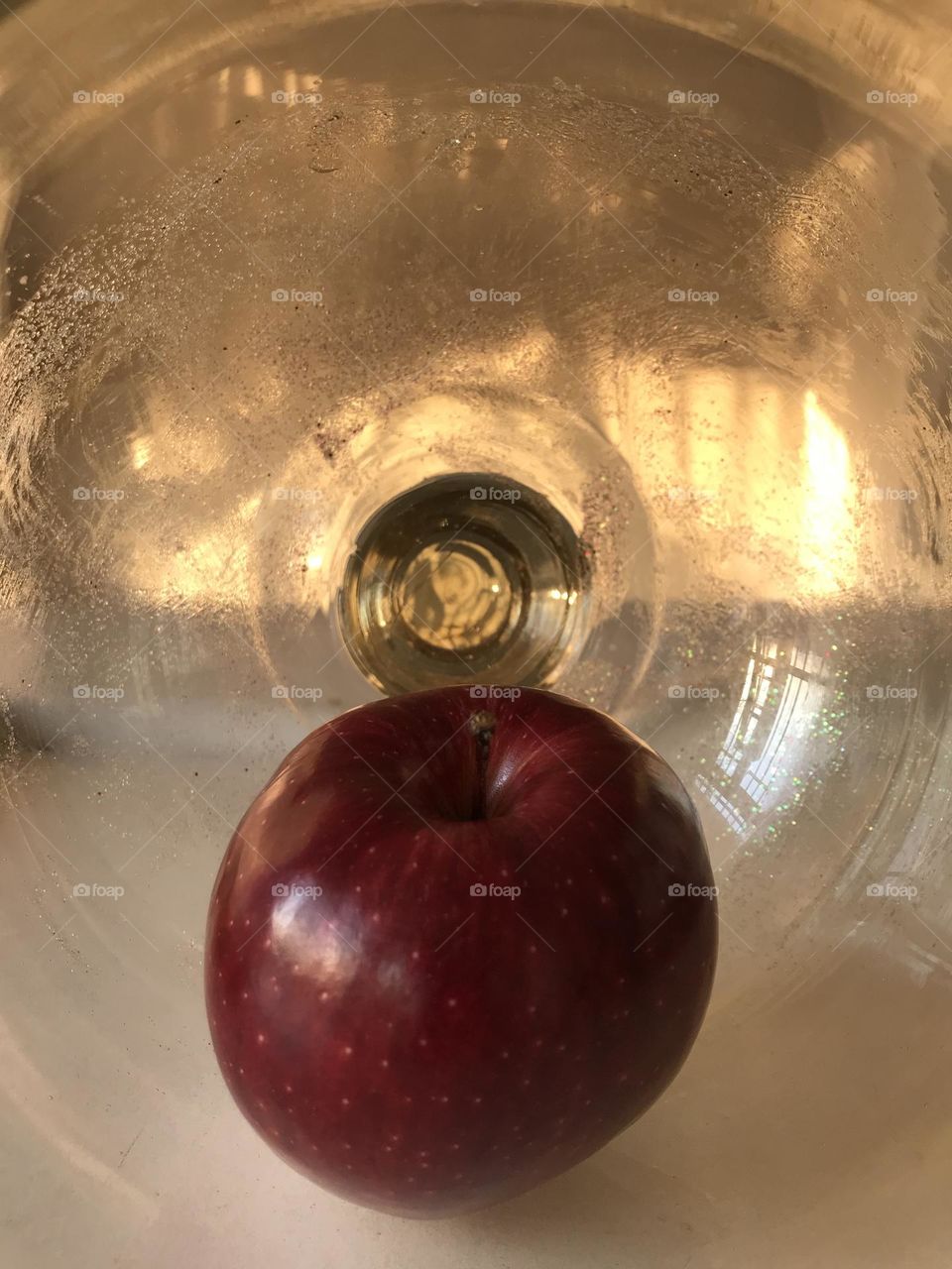 A red apple surrounded by the soft and loving light of the evening. The story of love and purity.