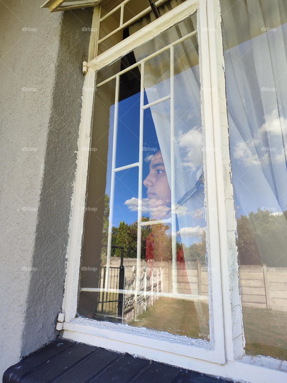 Young male looking out of the window