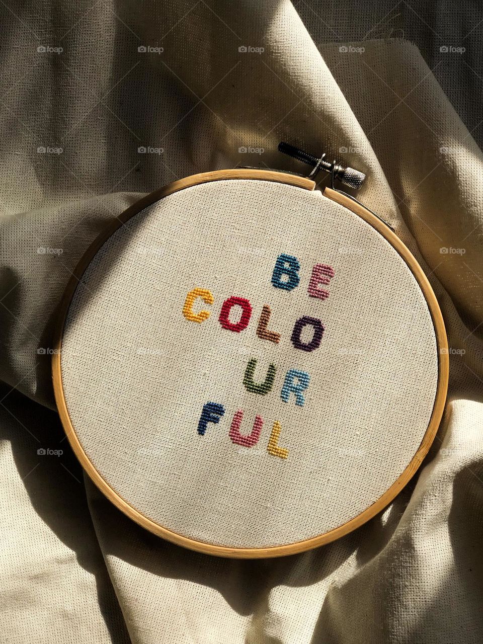 Cross stitched be colorful in a round wooden hoop, LGBT color 