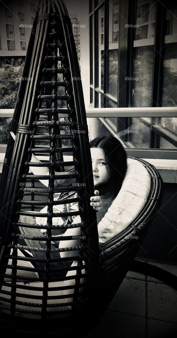 A girl on the swing in the balcony 