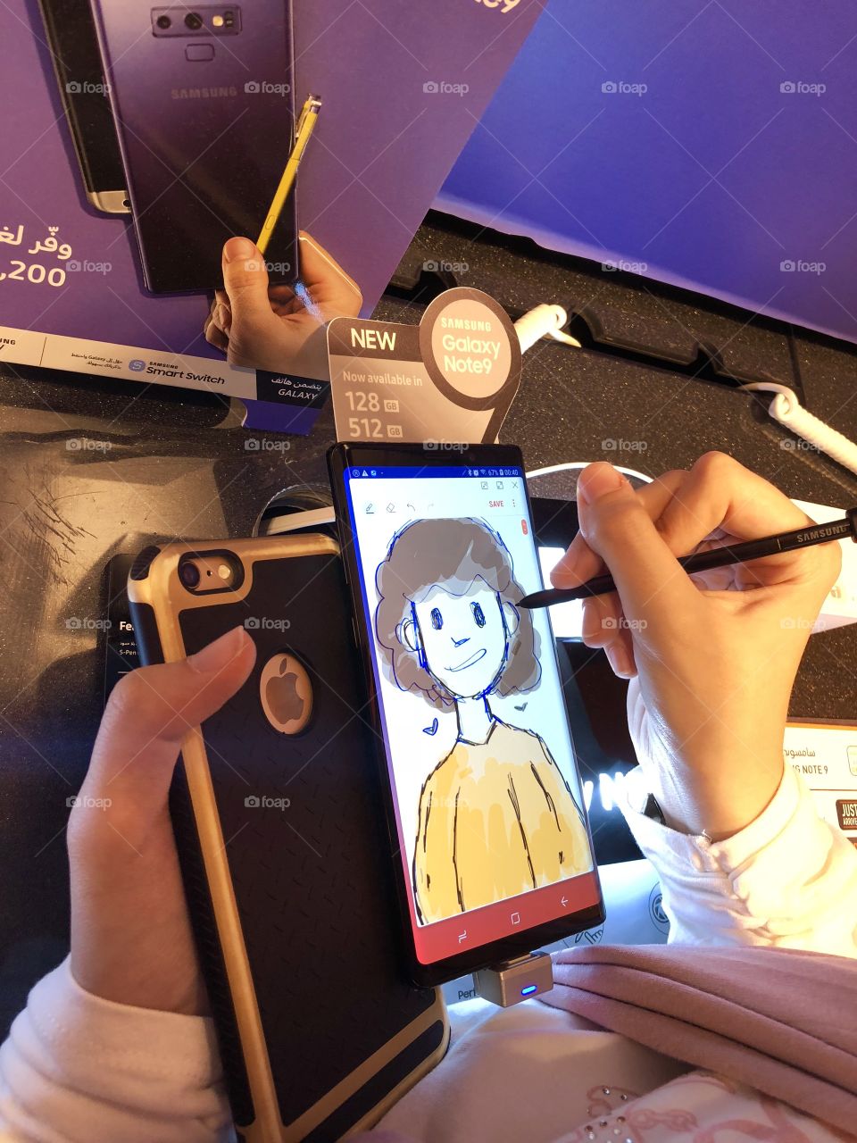 Teenager comparing Samsung Note 9 to Apple iPhone 6 plus to by drawing with stylus. Note 9 wins!  