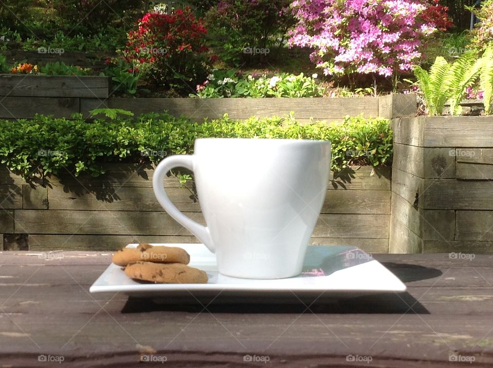 Enjoying a cup of coffee outdoors on a beautiful spring day.