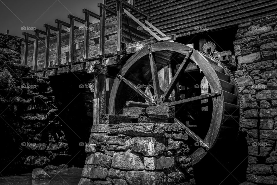 Black and white of the waterwheel and flume of the old gristmill at Historic Yates Mill County Park in Raleigh North Carolina. This the only mill left in Wake County that’s still operational. 