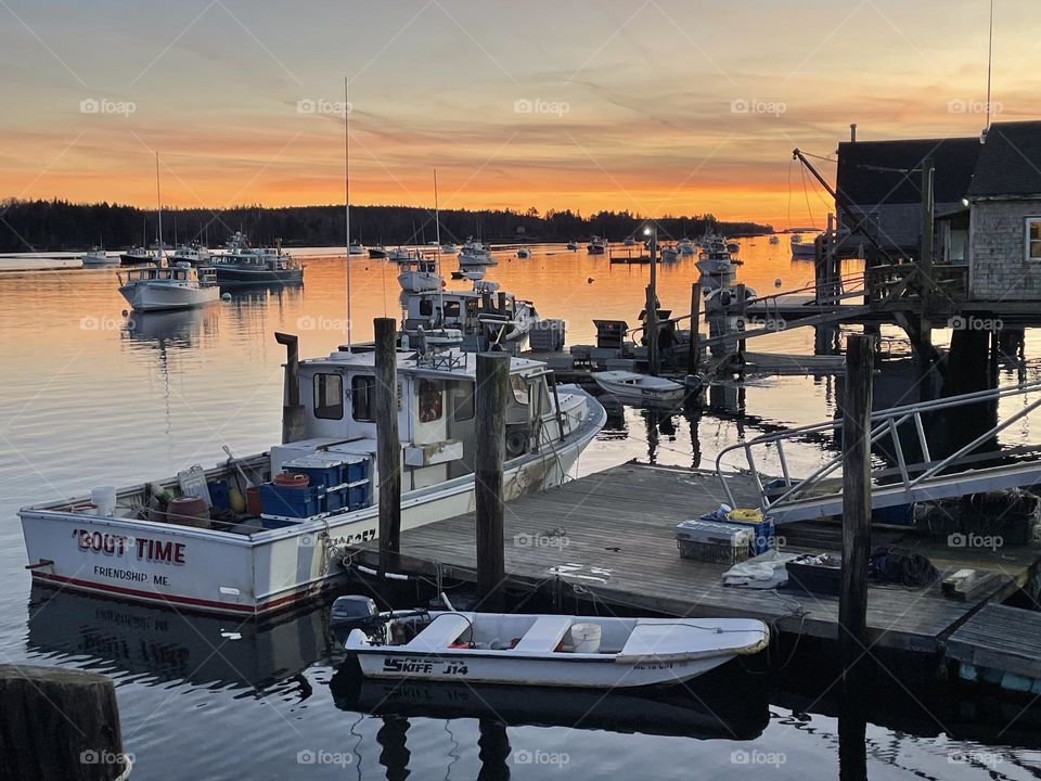 The last rays of sunset wash across the fishing harbor of Friendship, Maine