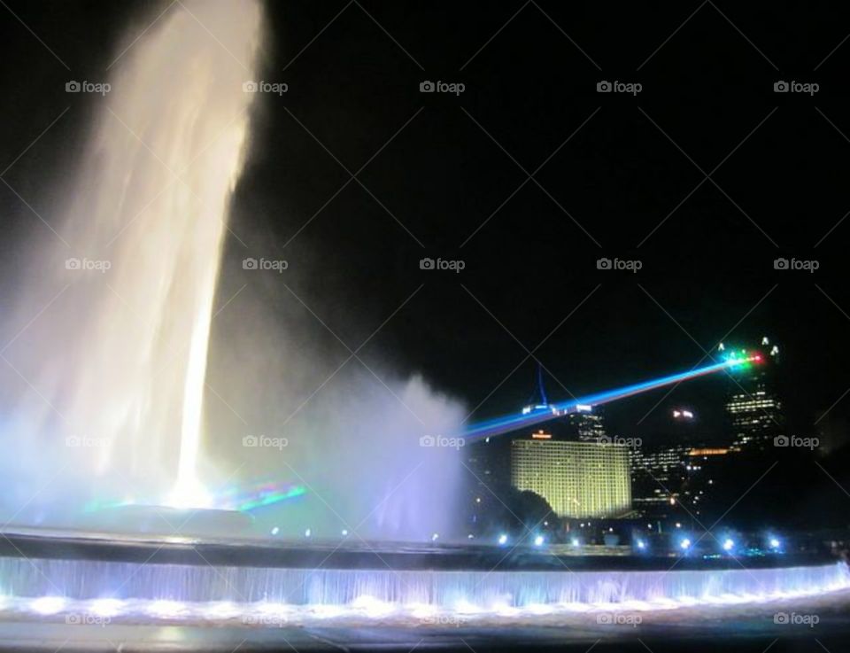 fountain lit up with a prism laser.