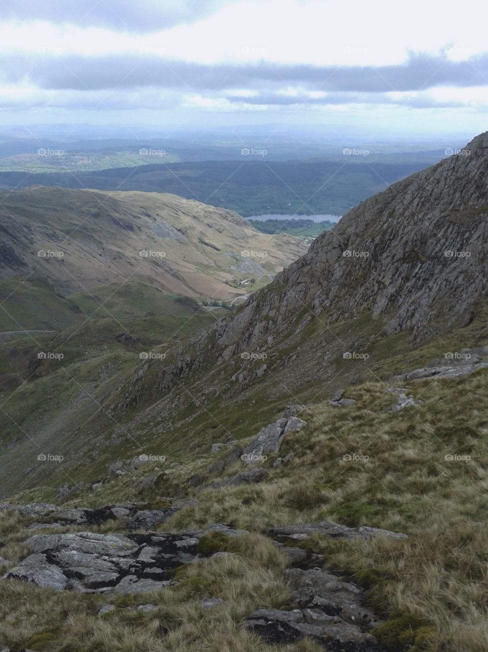 The view from atop the Old Man of Coniston truly is marvellous, the horizon stretching out for miles. The peaceful lake of Coniston Water can be seen in the background, the third largest lake in the Lake District.