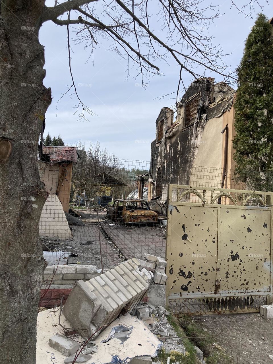 destroyed house and burned car in irpen, 2022