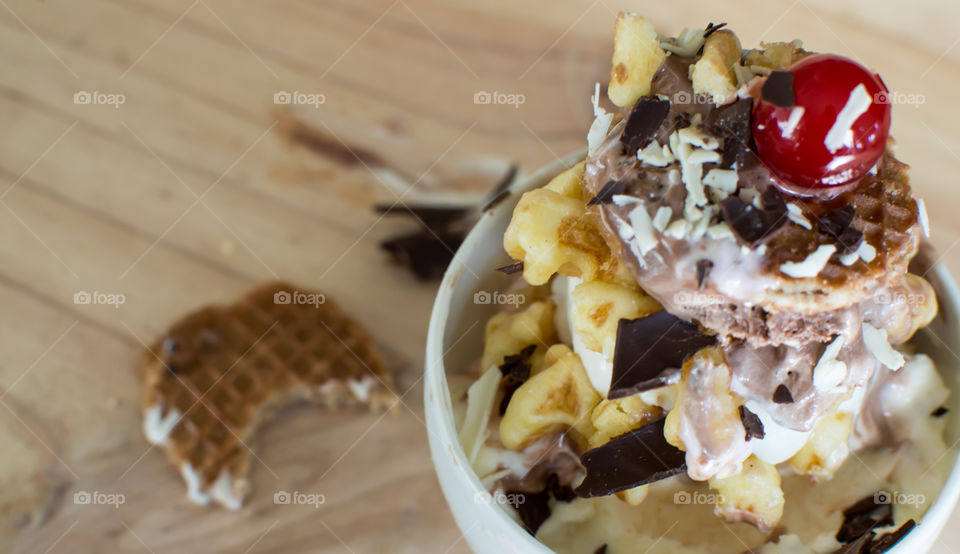 Waffles layered with ice cream in bowl