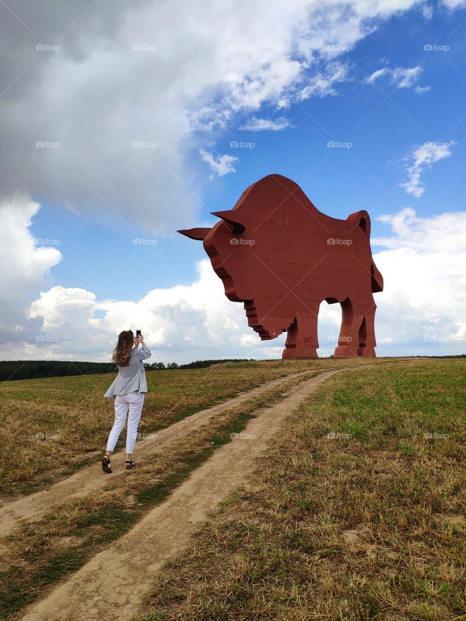 girl next to the bison figure