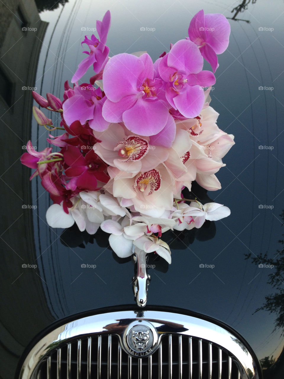 Wedding flower bouquet sitting on a Jaguar car