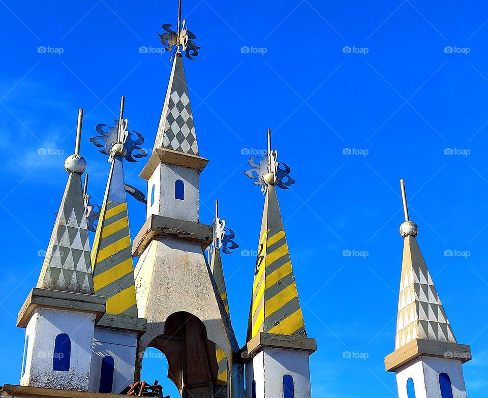 Triangles.  Against the backdrop of the blue sky, triangular domes of the towers
