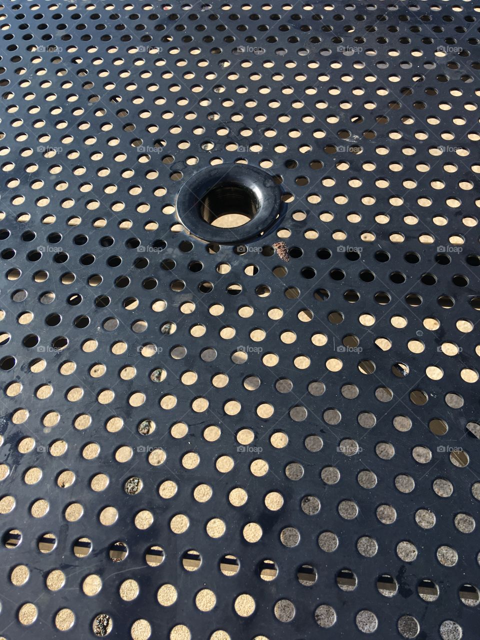 Shapes circles lines triangles an outside table at a restaurant you can see the shadows below.