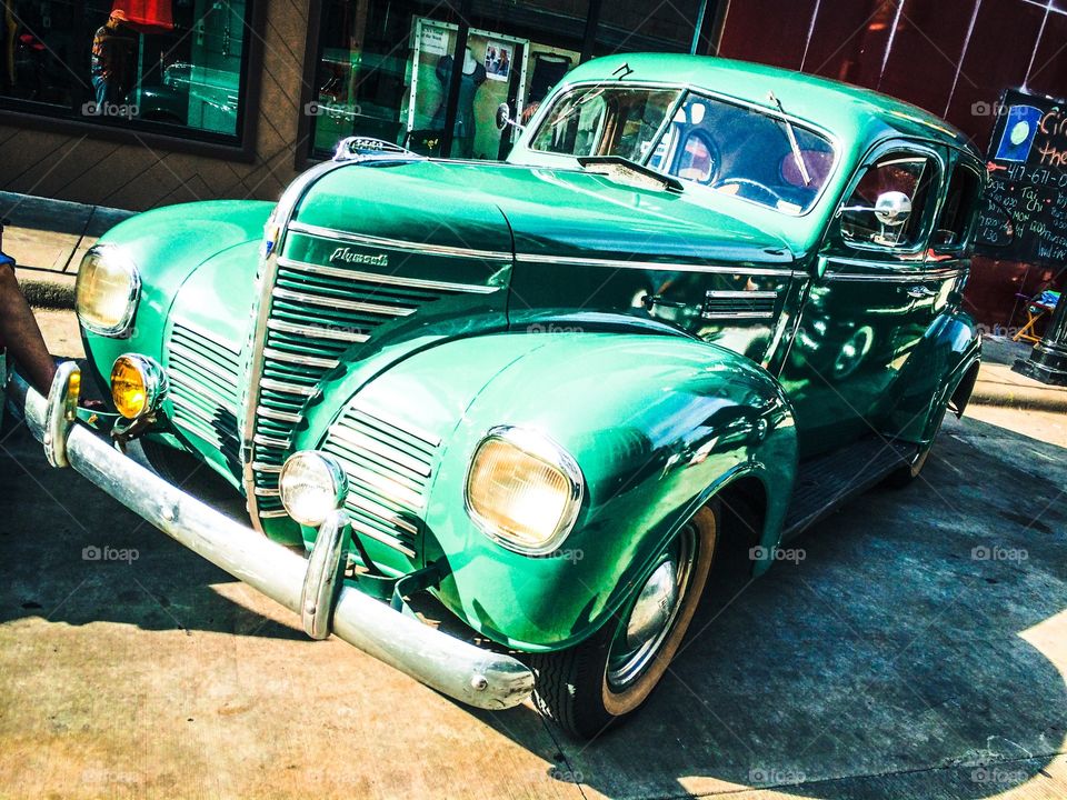 Old green car. When cars were cars and bumpers were made of chrome. 