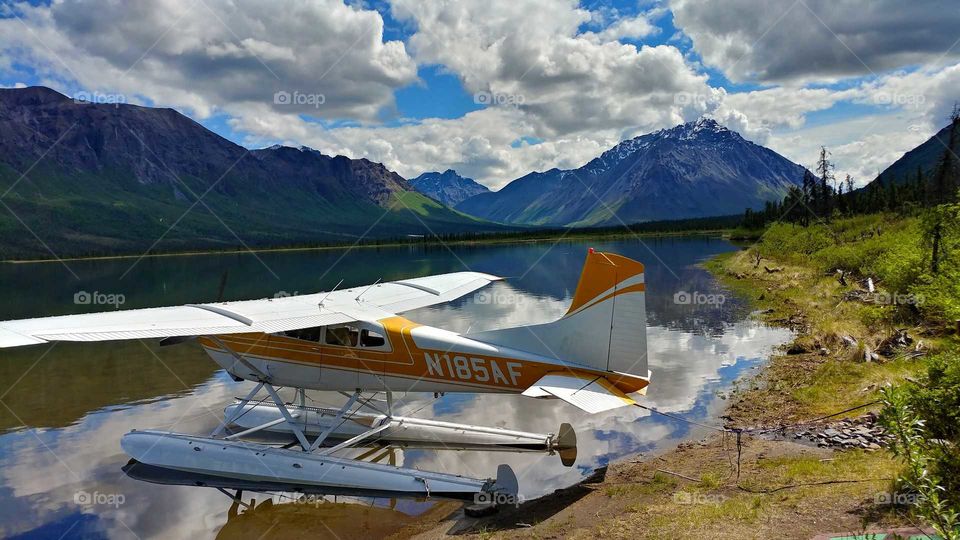 A float plane moored on a Alaskan wilderness lake on a beautiful early summer day.