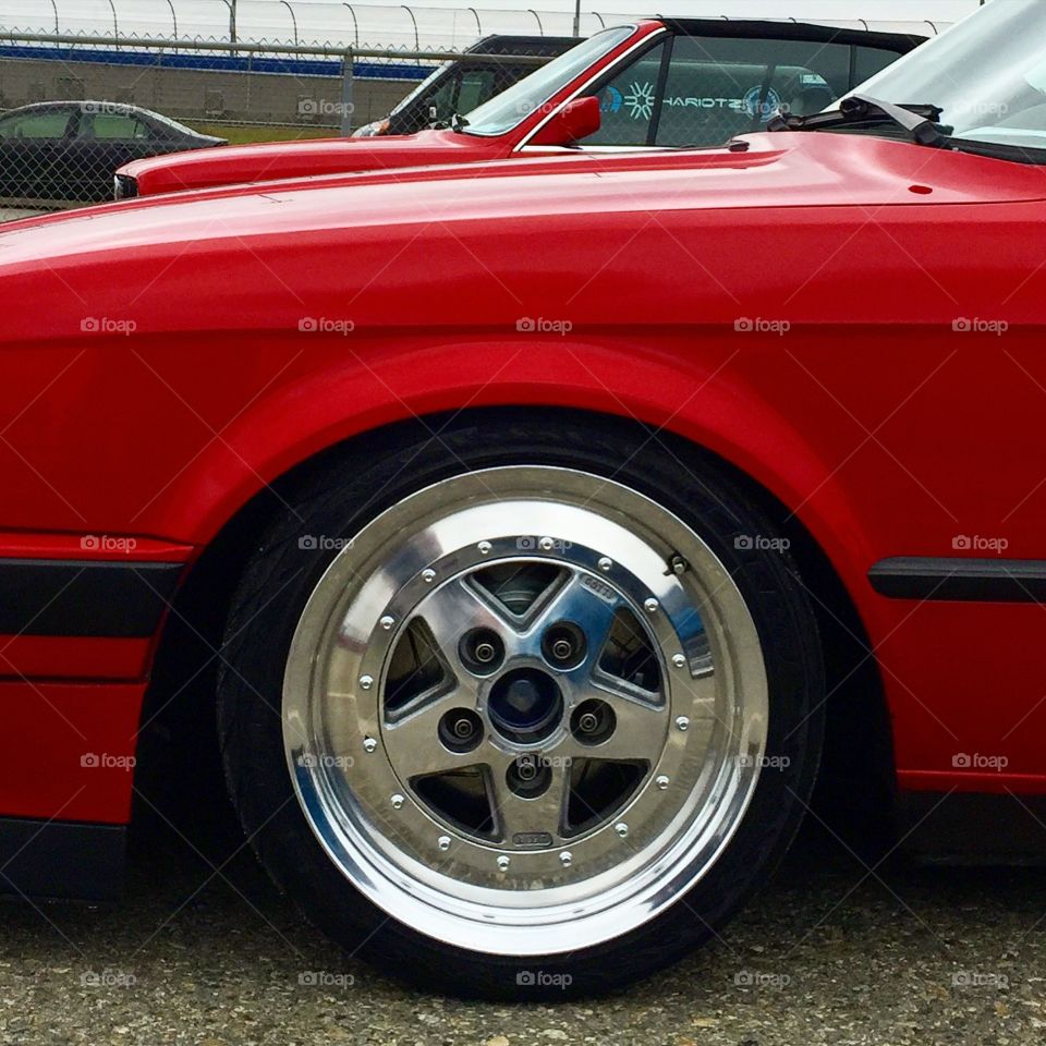 Classic Wheel. Classic shiny wheel on classic red car 
