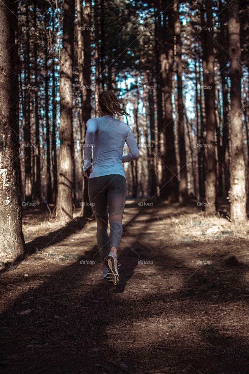 Young woman jogging in the woods