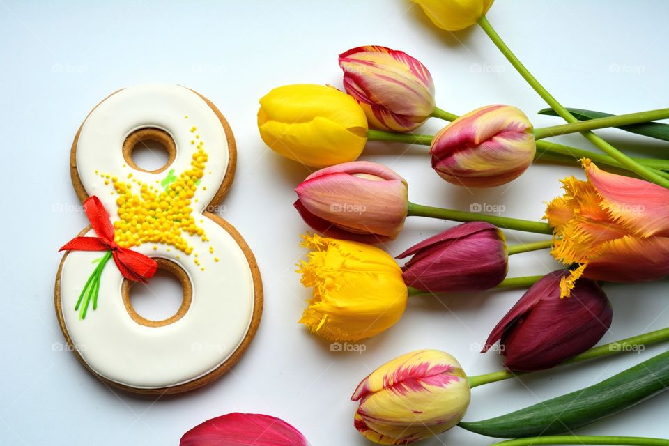 8 March gingerbread and colorful tulips on a white background women's day