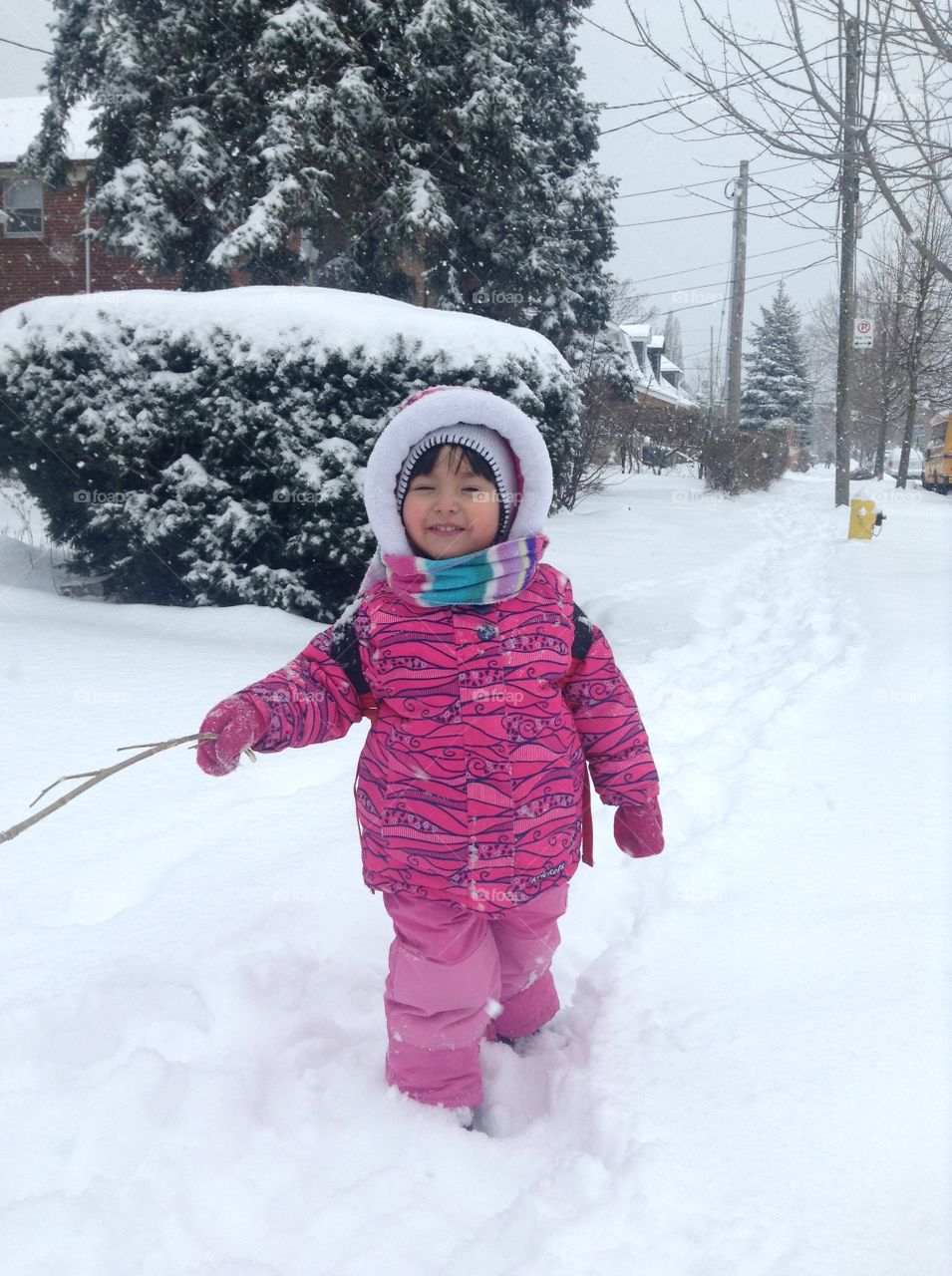 Small girl holding stick in hand