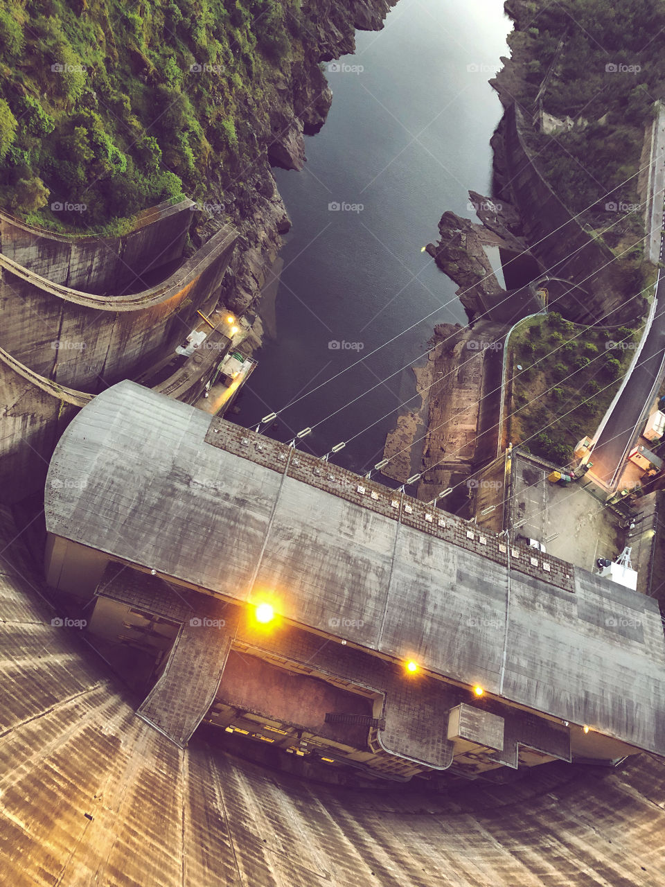 The dam at Castelo Do Bode is lit up for the nighttime, downward view of the dam and river