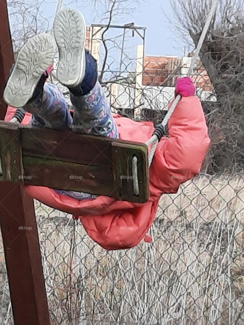 kid on a swing in winter