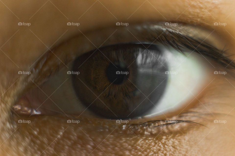 Macro close eyes of Asian kid's. Natural deep dark color iris.