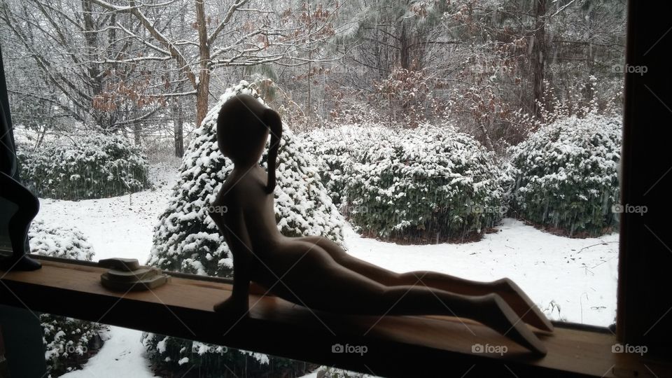 Yoga statue window snow