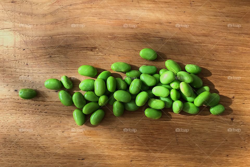 Green soy beans on table