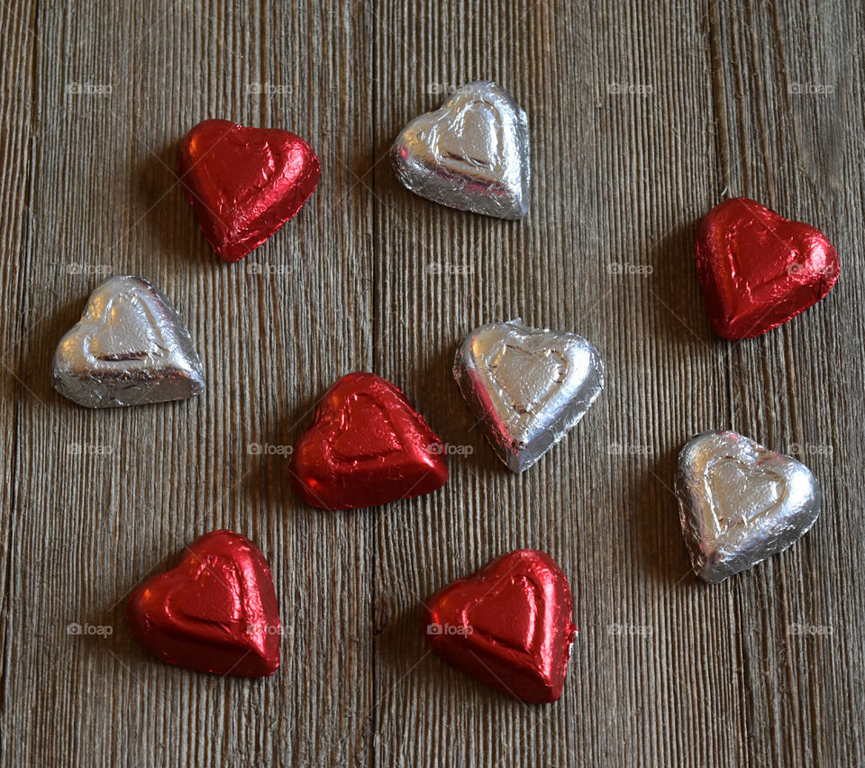 Heart shaped candy on a wood background