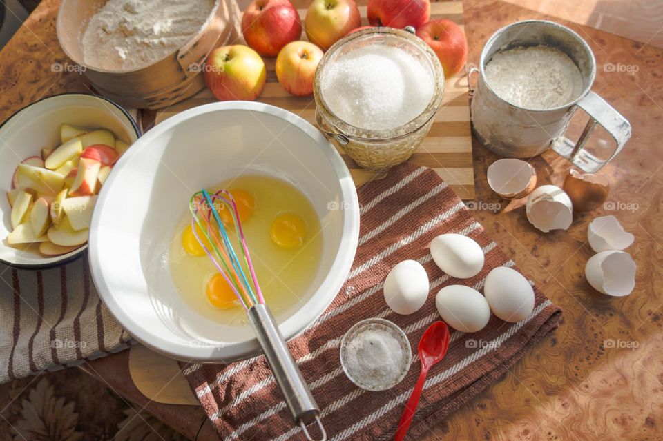 Making homemade puffed apple pie with eggs, sugar and flour.