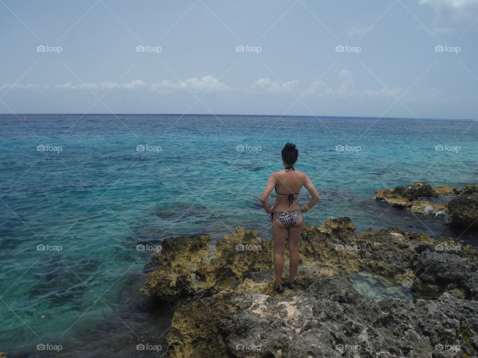 woman on rock. ocean