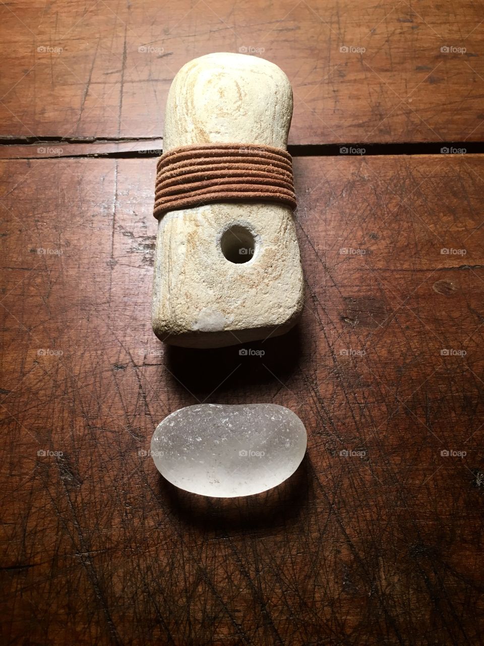 Beach glass and leather bound stone with natural hole