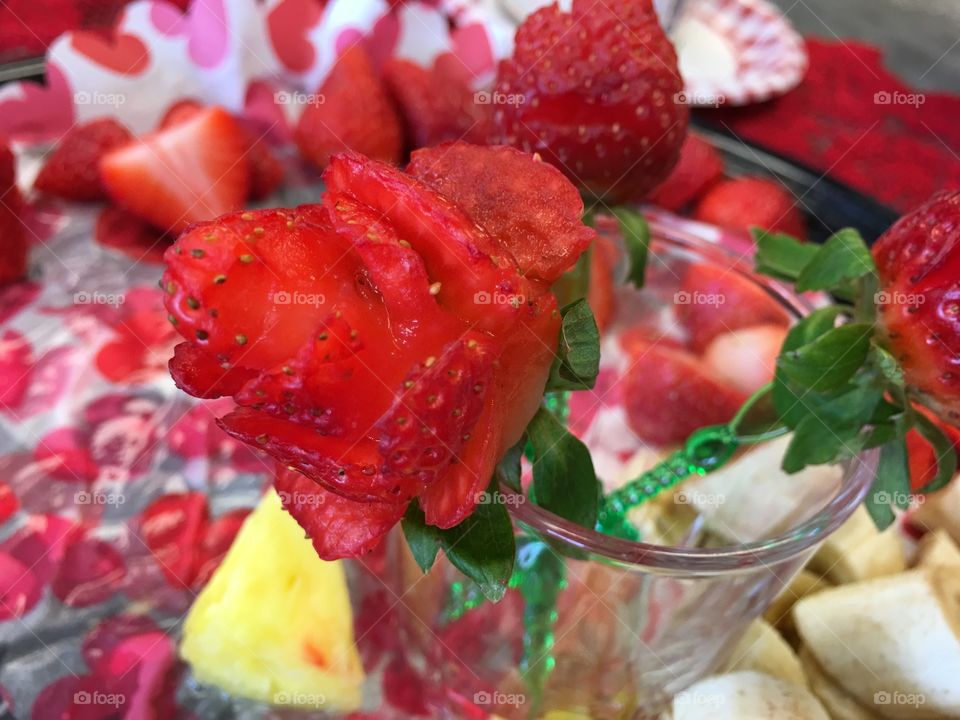 Strawberry made into rose garnish on fruit platter centerpiece food design and decorative ideas 