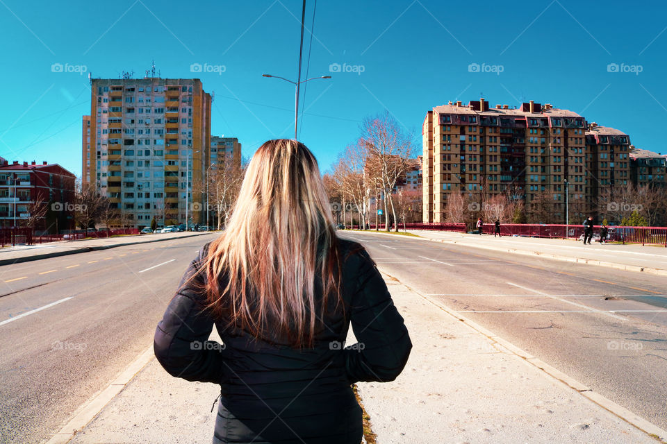 Blond woman in the empty streets