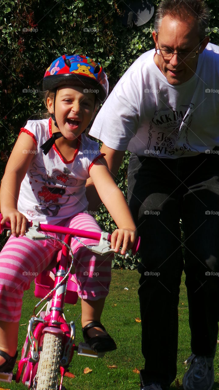 parenting,  father and daughter,  bonding while learning to ride a bicycle