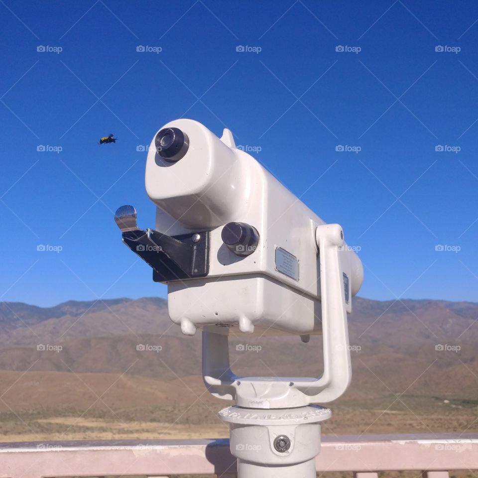 Large bumblee looking through Arizona rest stop telescope