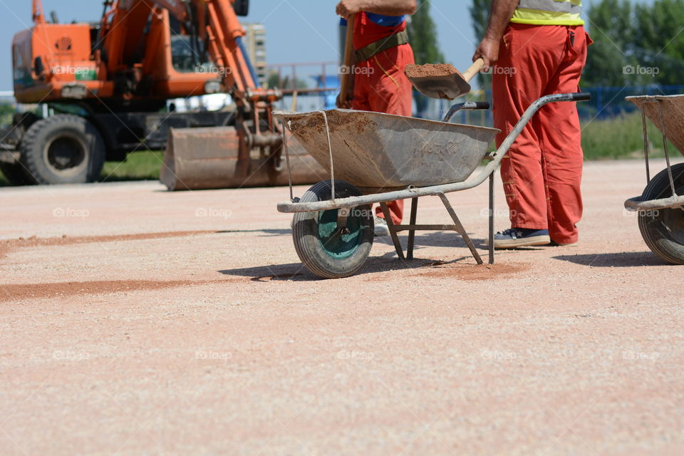 Man with a shovel on construction site