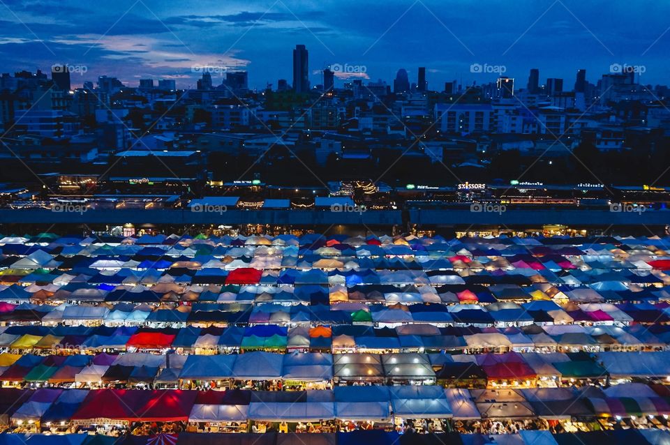 Illuminated stalls of the Train Night Market at dusk in Bangkok... one of the absolute coolest things I’ve ever seen. This is the view from the parking garage of the neighboring mall.