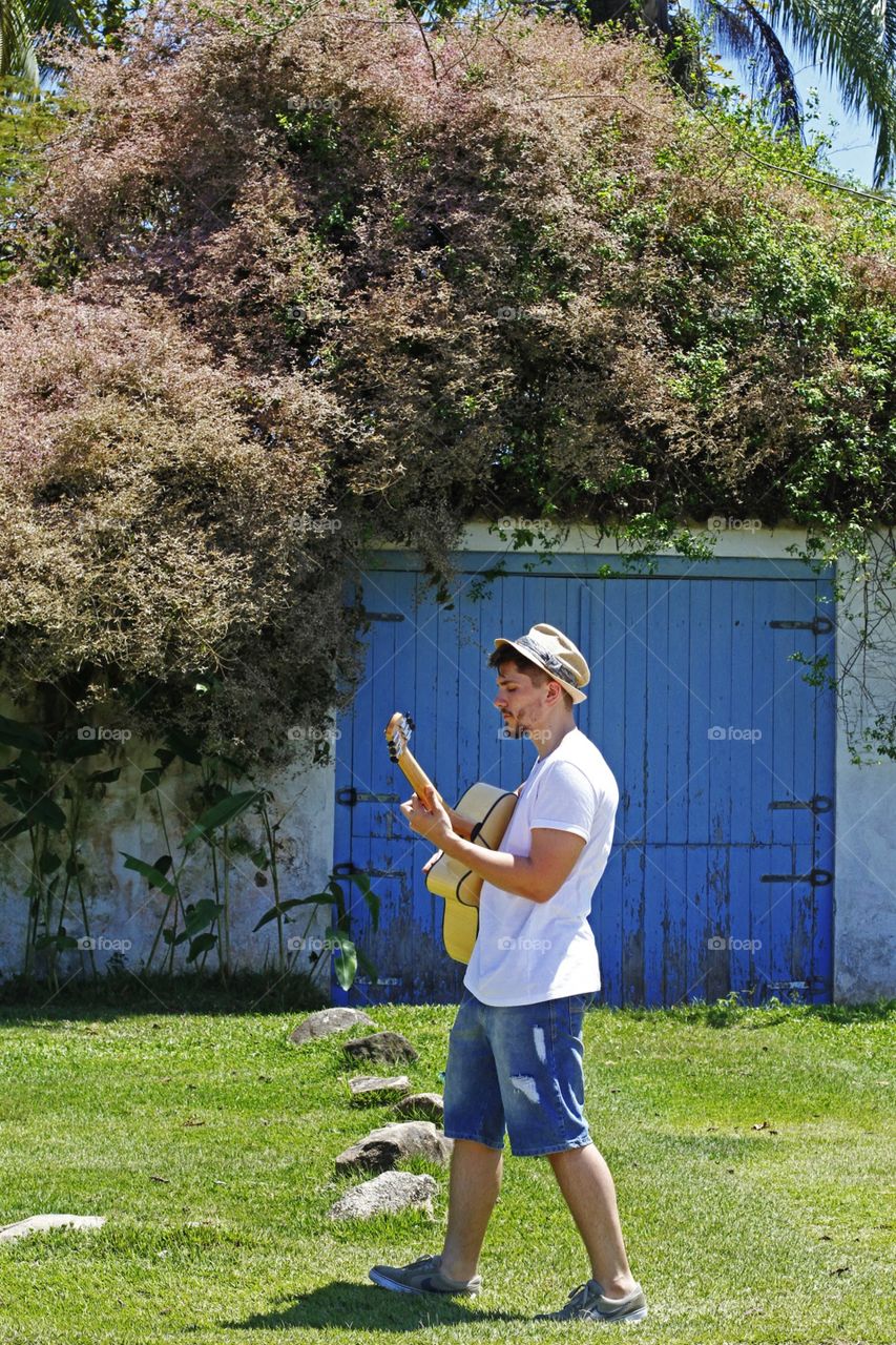 Boy playing guitar in spring