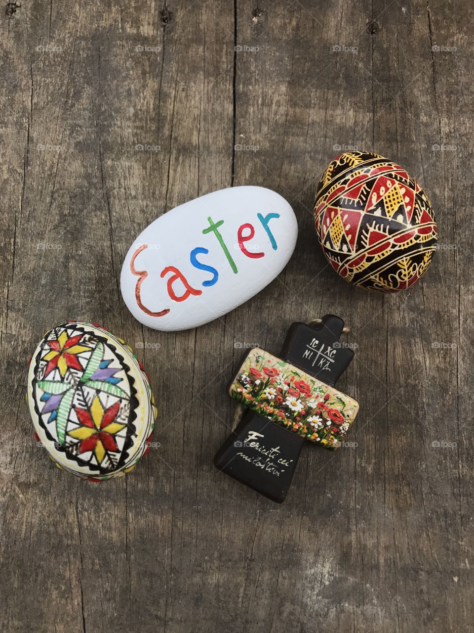 Happy Easter composition with painted orthodox crosses and a carved and painted stone