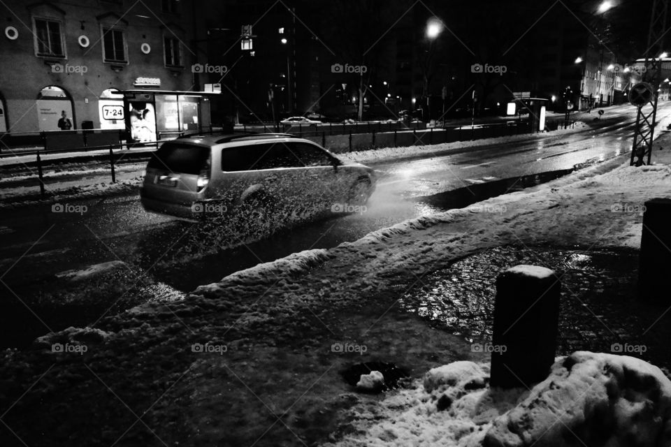 Helsinki, Finland - 9 January 2012:  Car driving Runeberginkatu in the center of Helsinki in wet and dark winter weather.